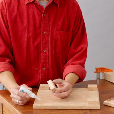 Glue being used to build a tiered serving tray.