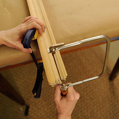 Chair rail molding is shaped and cut with a coping saw.