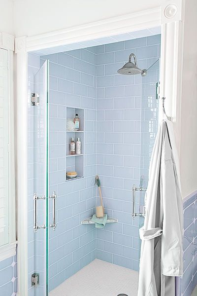 a shower with a glass door in a small bathroom