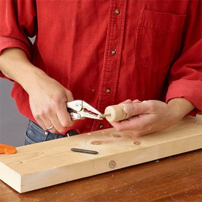 Glue being used to construct a tiered serving tray.