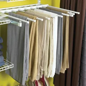 pants hanging on hangers in a closet