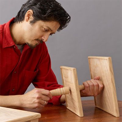 A man constructing a tiered serving tray.