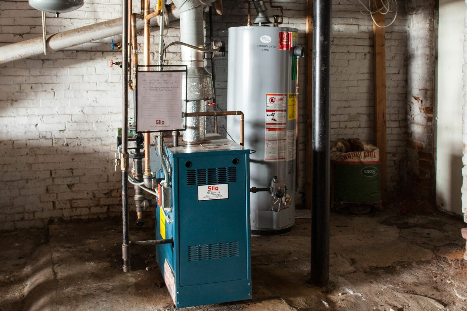 A basement with several pipes and tanks.
