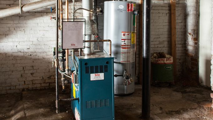 A basement with several pipes and tanks.