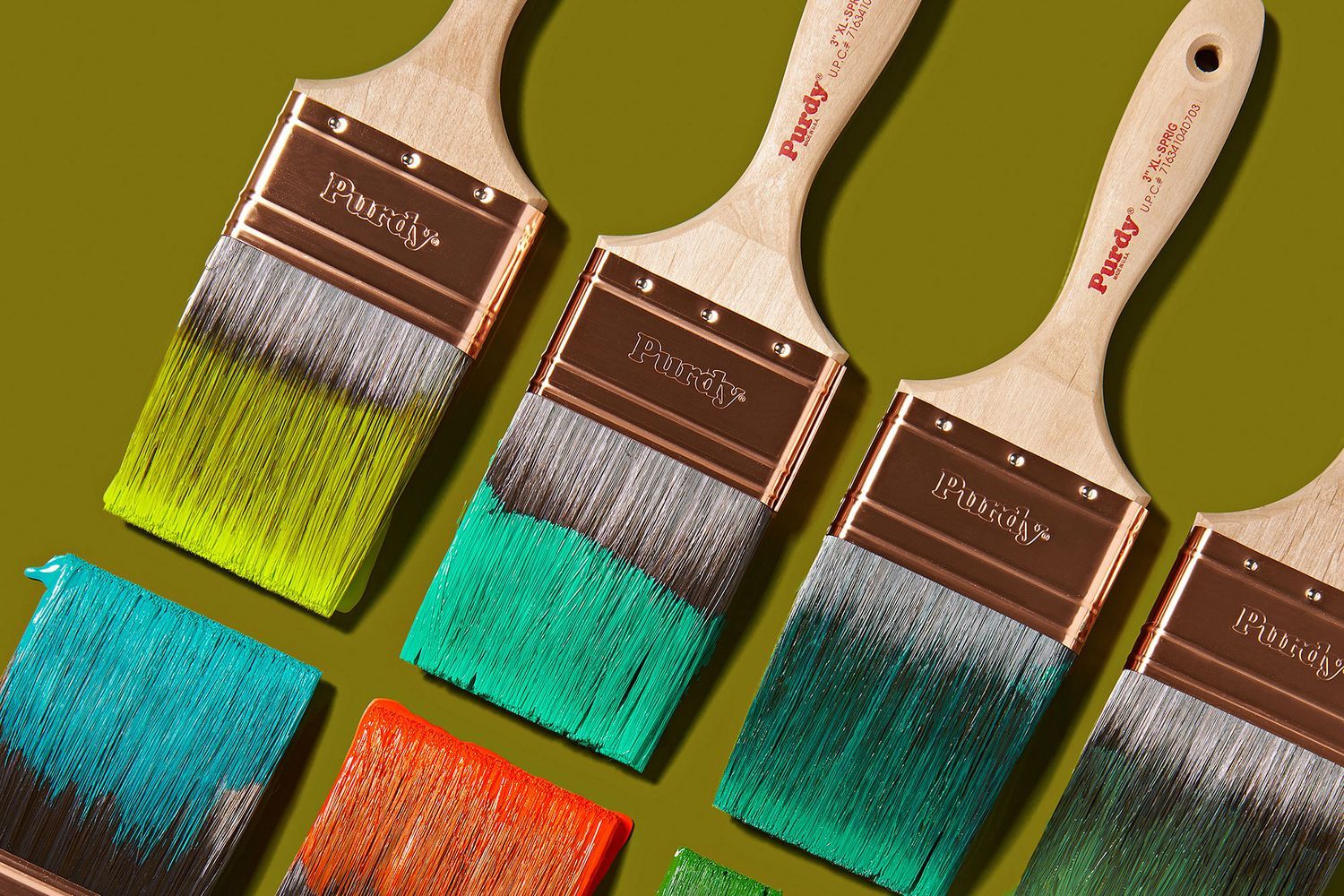Paint brushes dipped in paint.