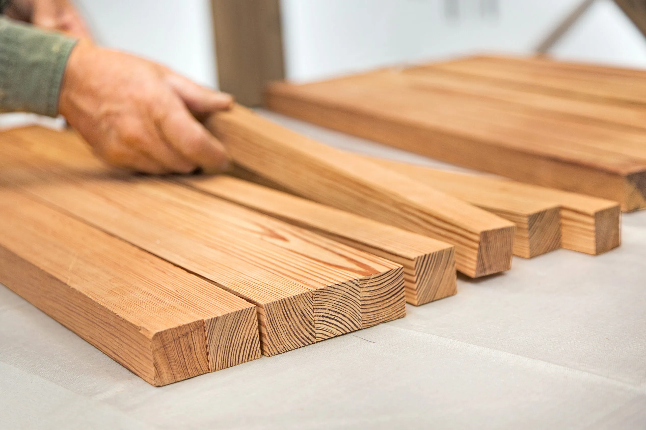 A man is pictured alternating the grain of his end grain cuttting board.