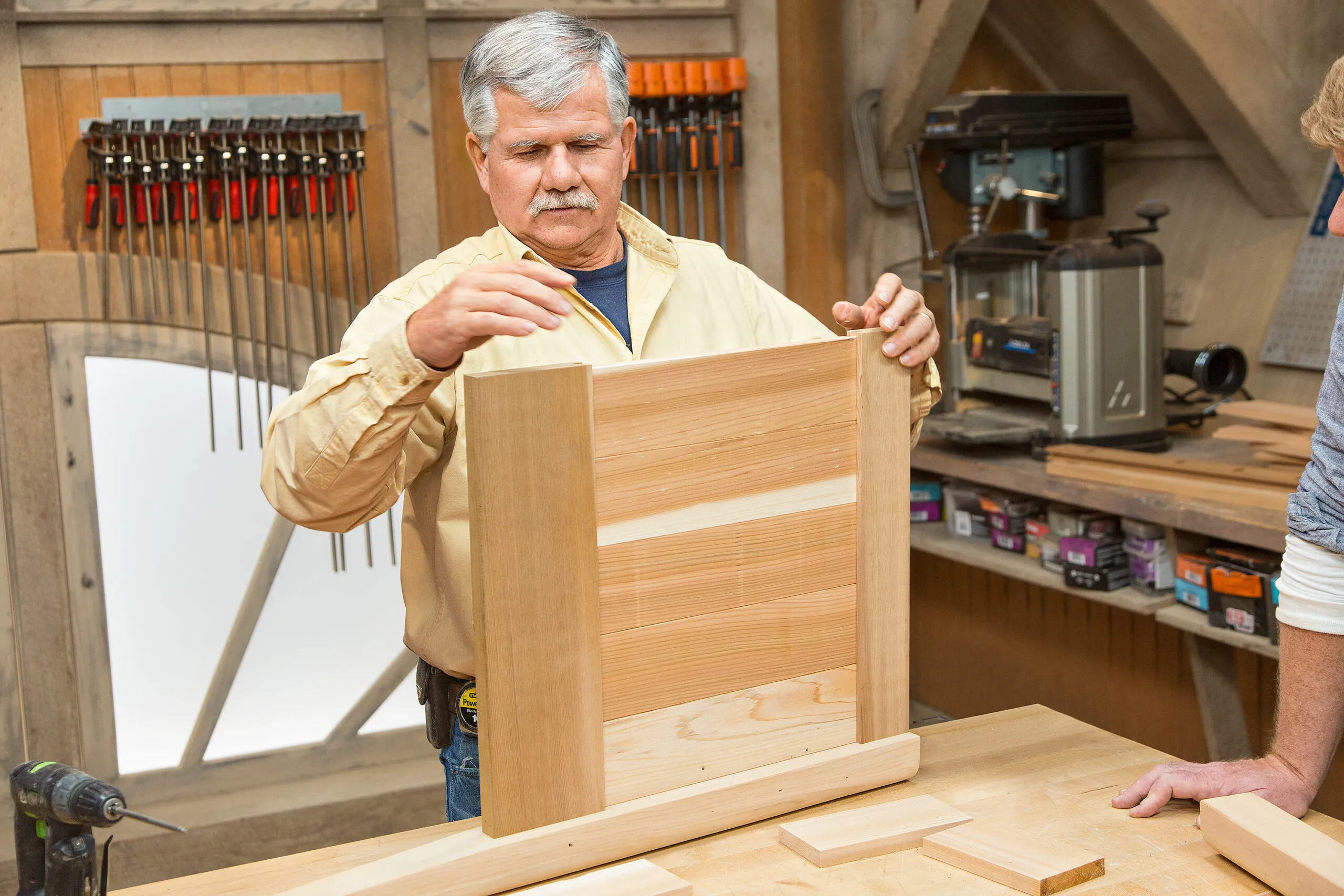 Tom Silva assembles the the first side of the cedar planter box.