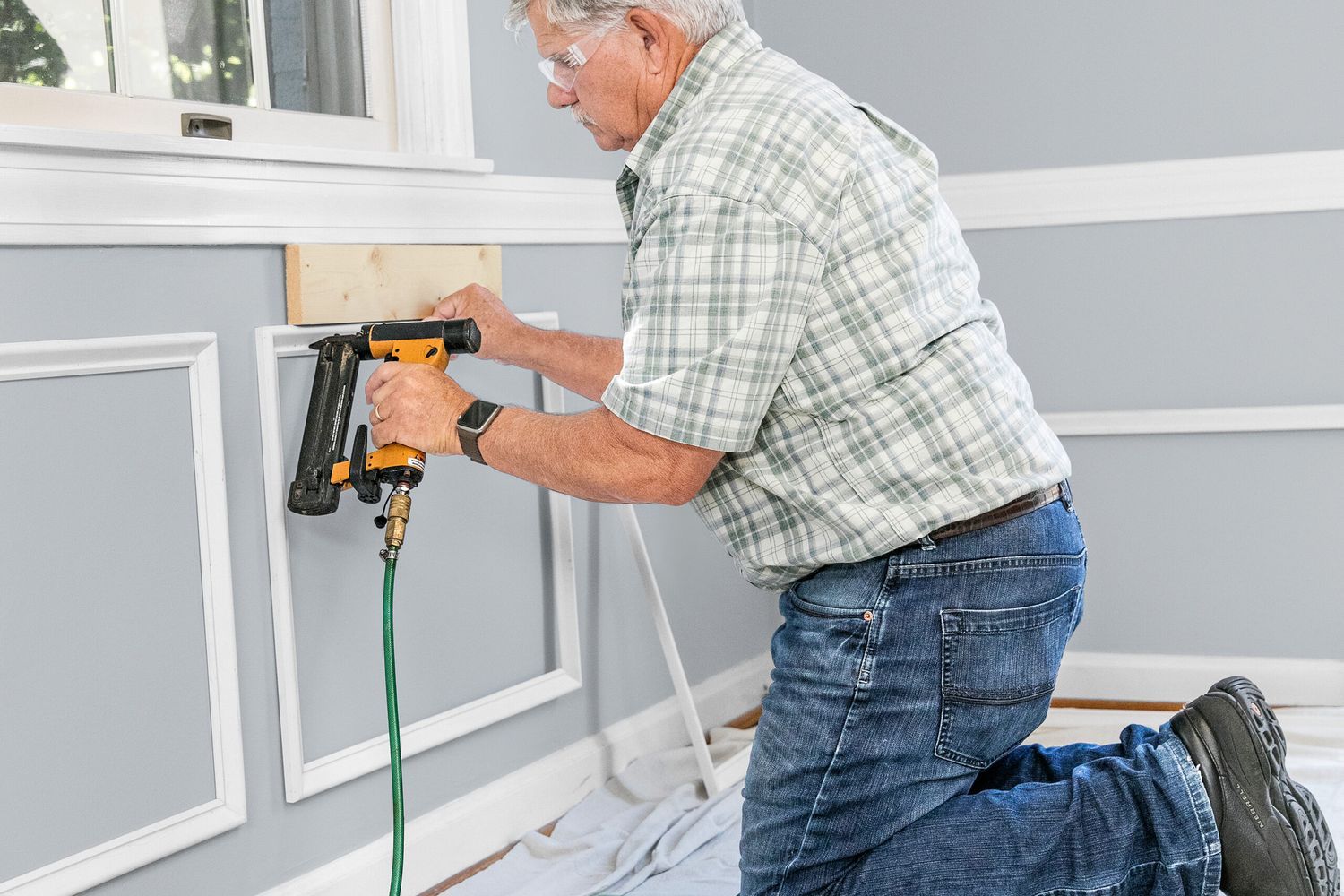 Tom Silva installing wainscoting.