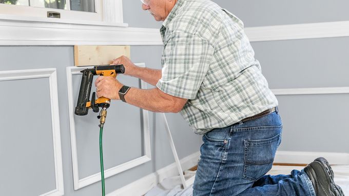 Tom Silva installing wainscoting.