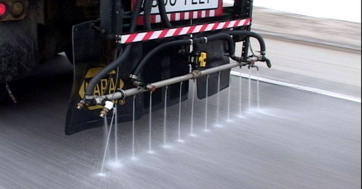 a de-icing truck on the streets spreading de-icing liquid