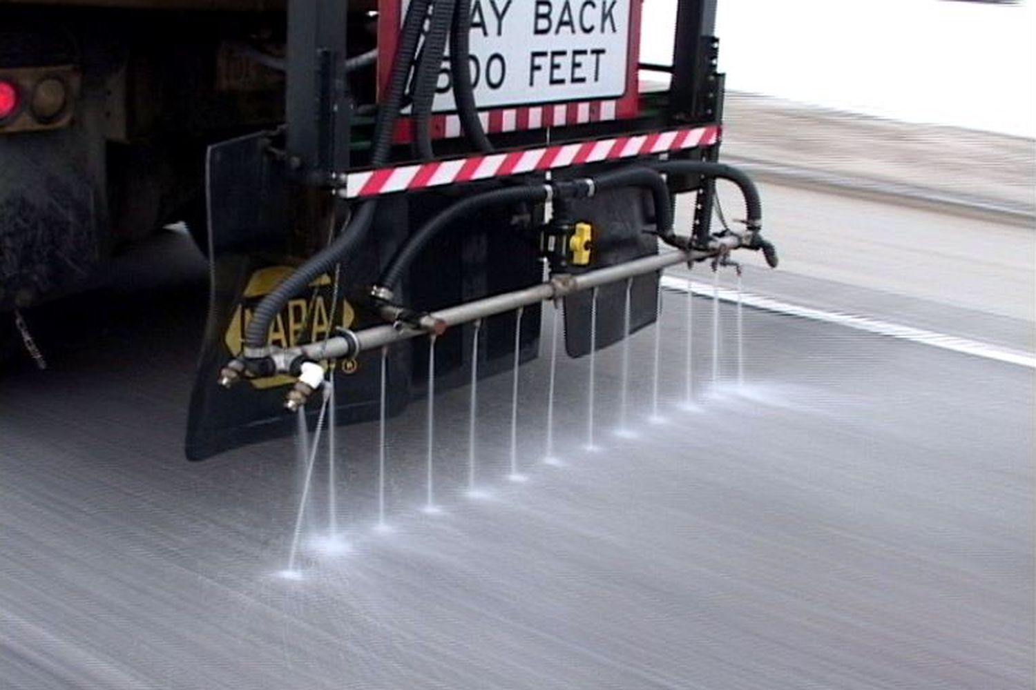 a de-icing truck on the streets spreading de-icing liquid