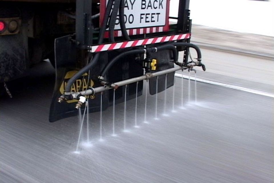 a de-icing truck on the streets spreading de-icing liquid