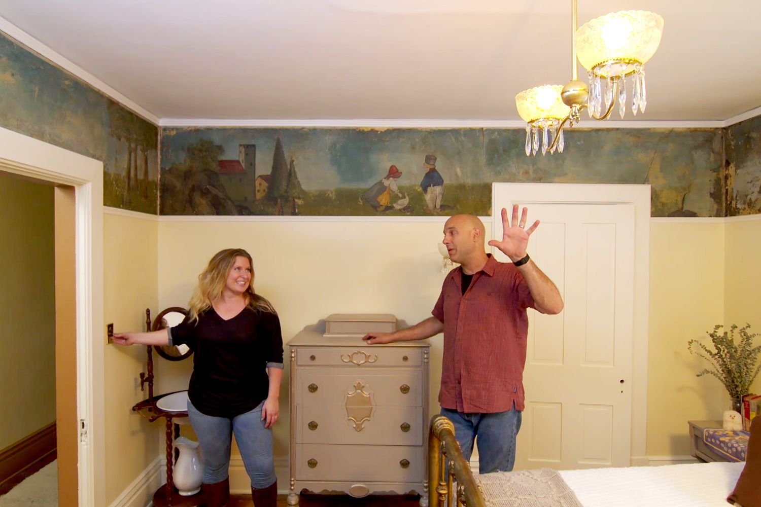 A couple rewiring a light fixture.