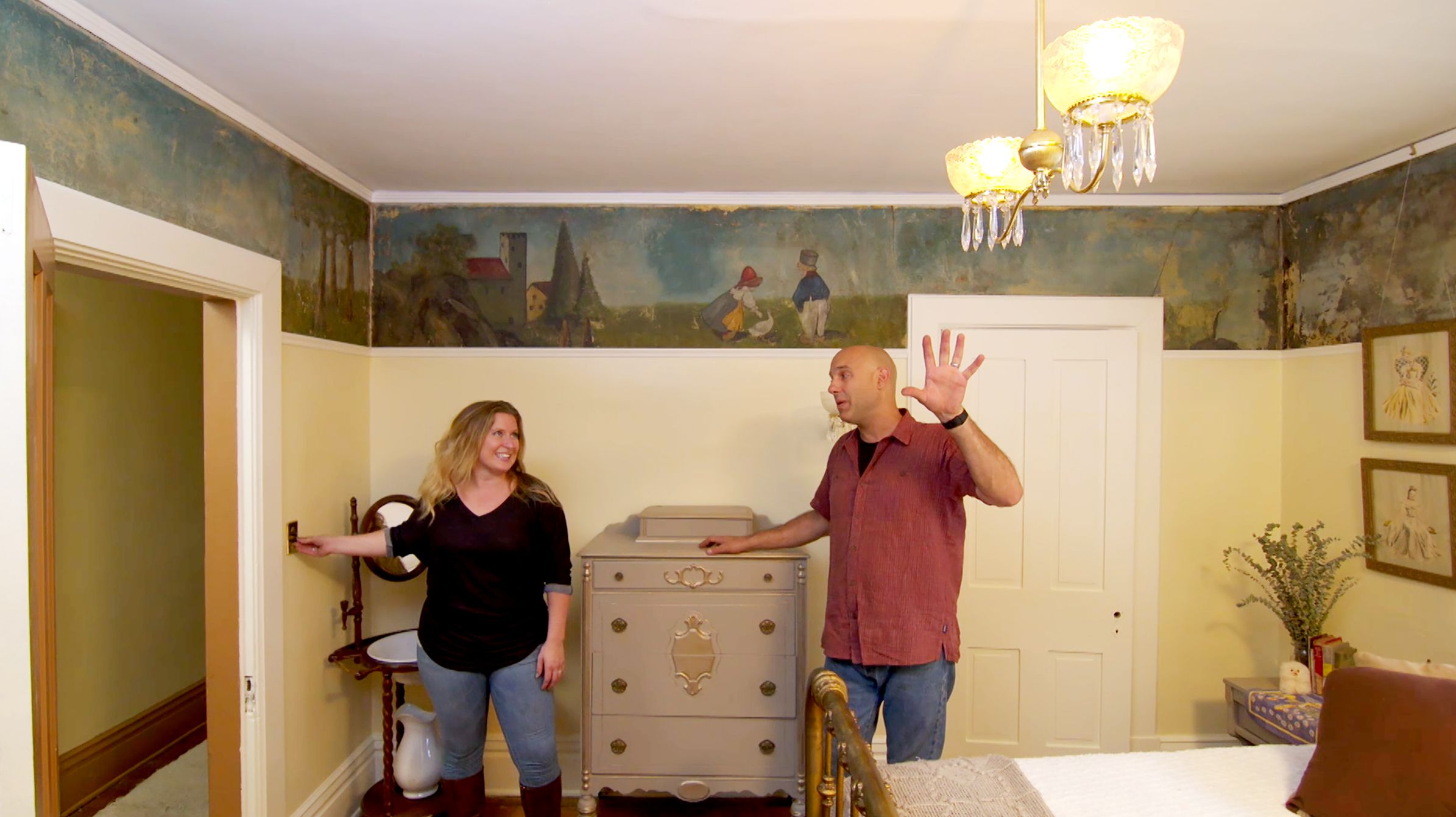 A couple rewiring a light fixture.