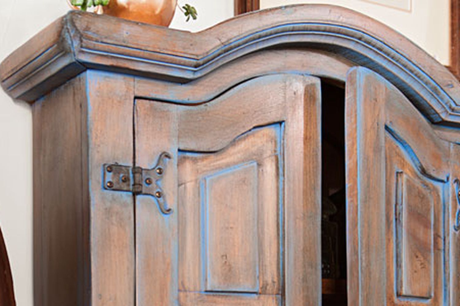The top of a color washed patina on a cabinet.