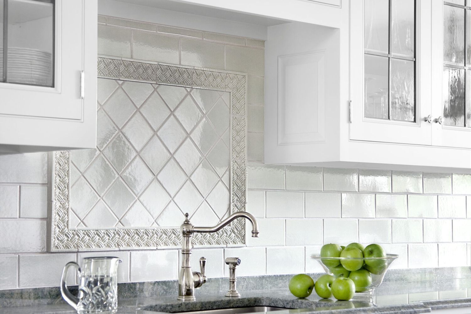 White kitchen with a white ceramic subway tile backsplash.