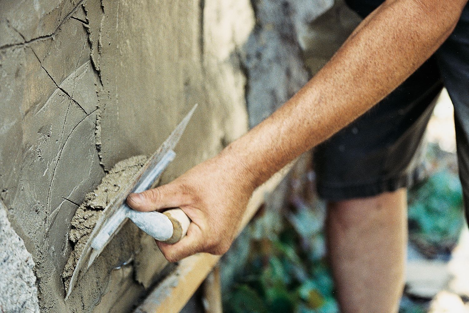 Stucco being applied to a wall to replace damaged stucco.