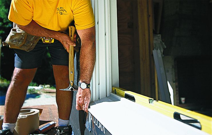 hammering a window frame in place