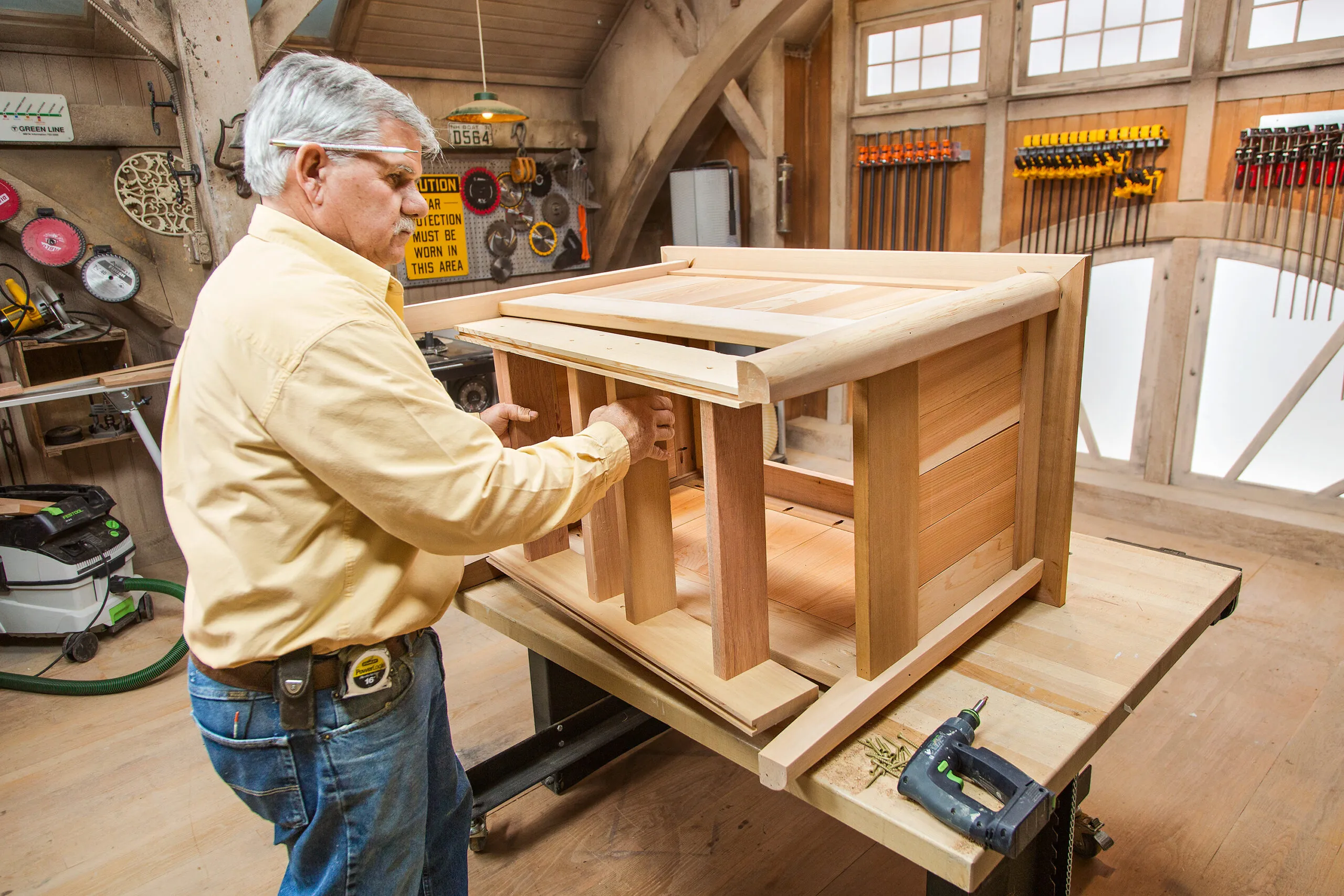 Tom Silva installs the base into the cedar planter box.
