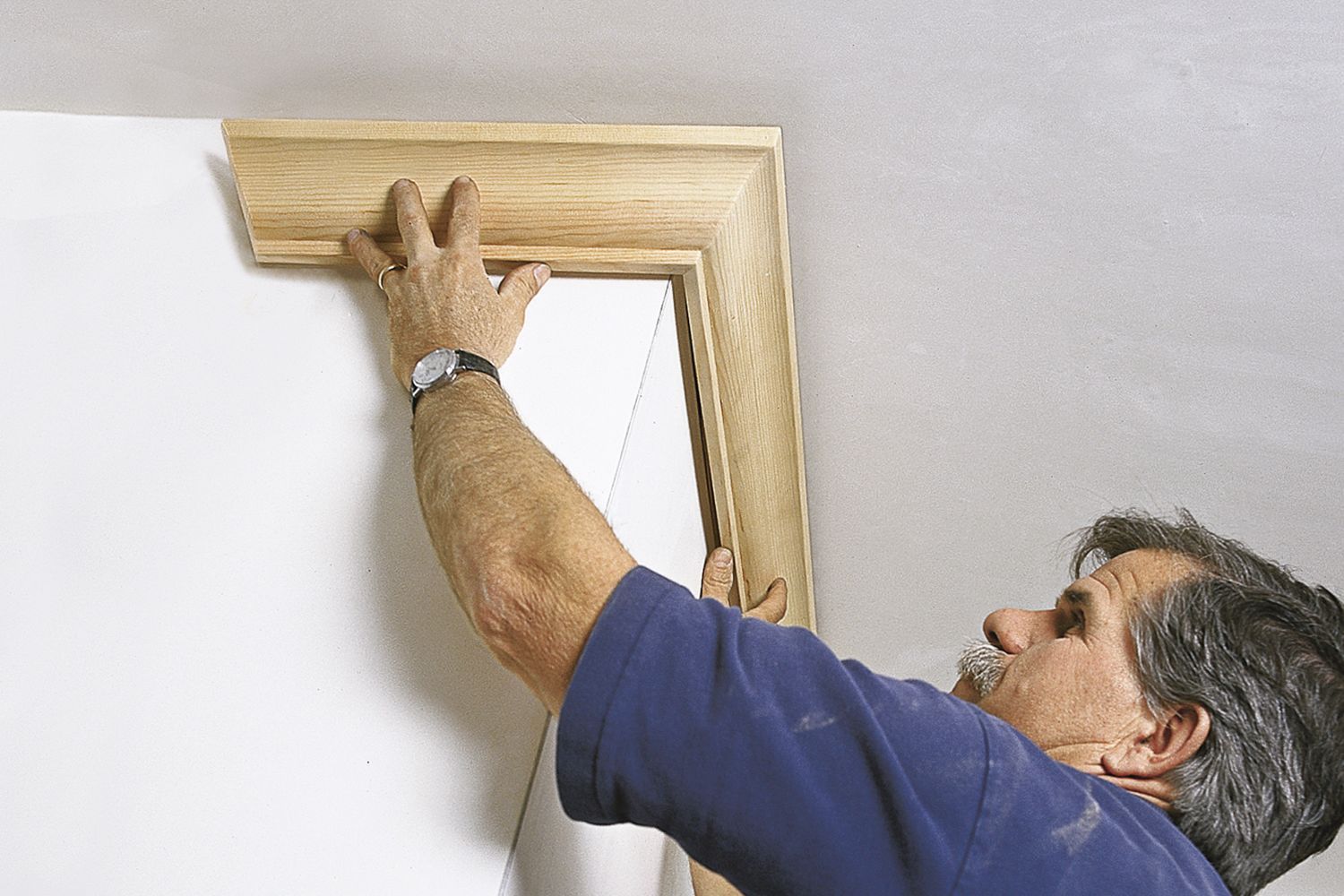 Tom Silva installing crown molding.