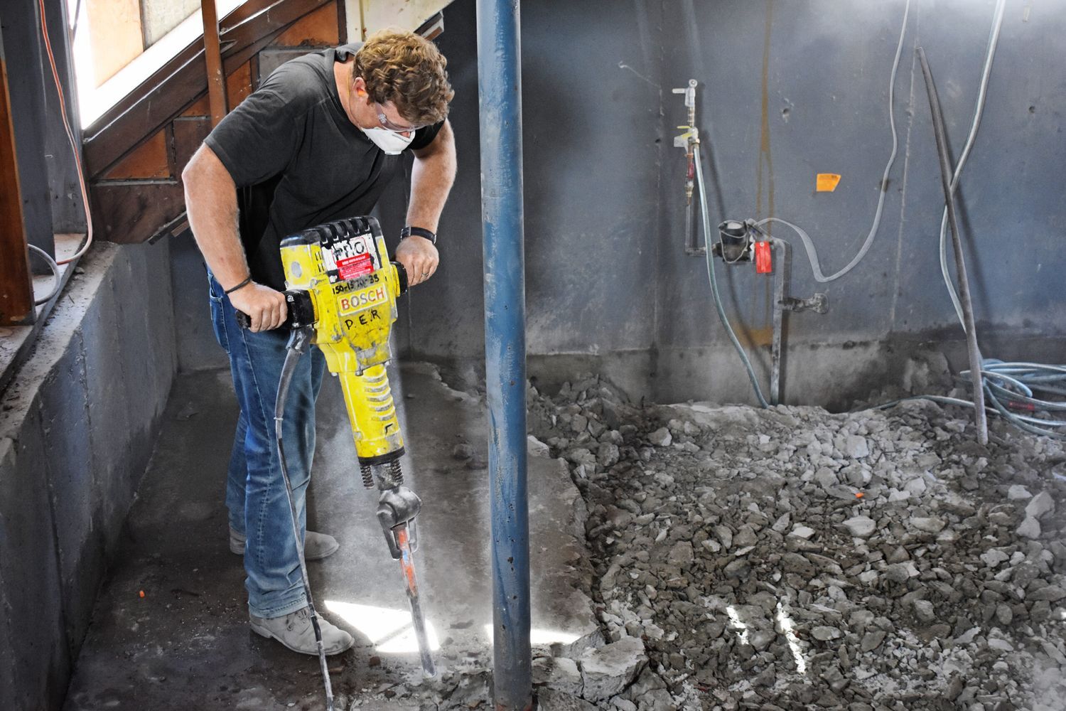 Kevin O'Connor breaks up concrete to be removed.
