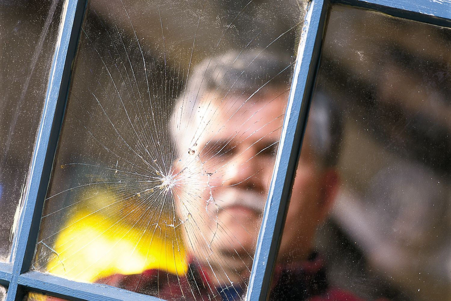 A man in front of a newly replaced window pane.