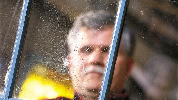 A man in front of a newly replaced window pane.