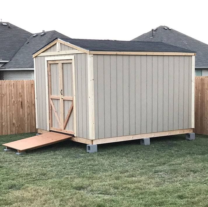 a large backyard shed with a ramp