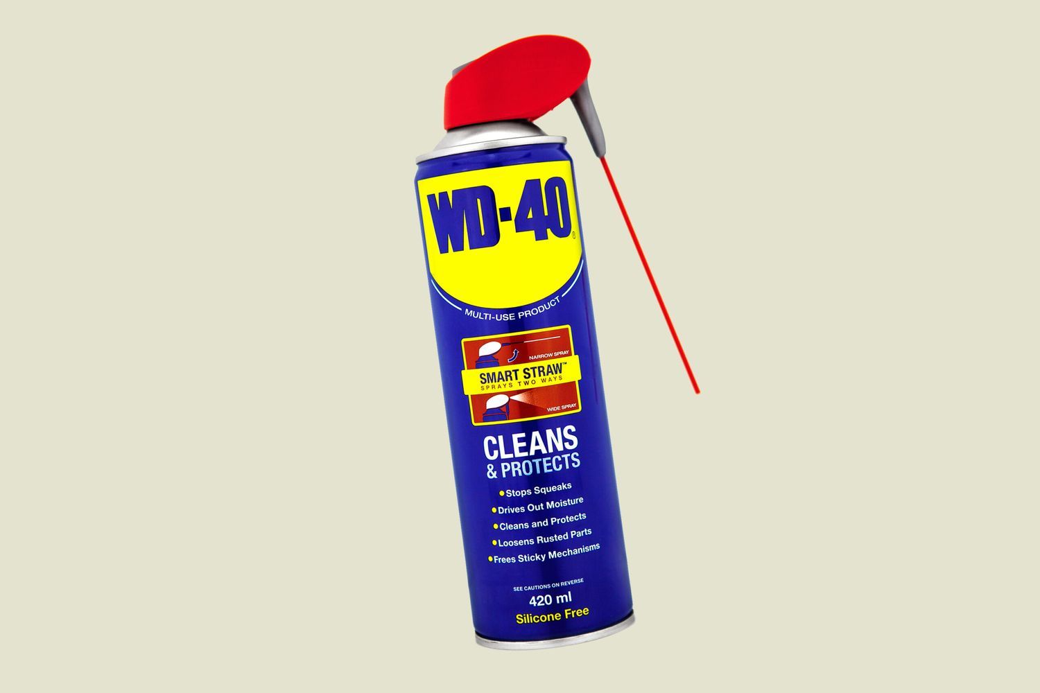 A can of WD-40 against a beige background.
