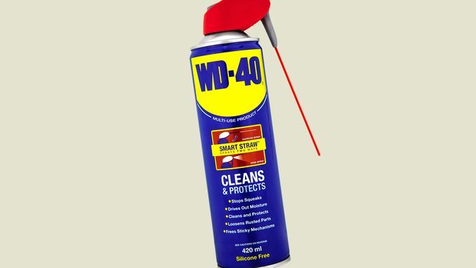 A can of WD-40 against a beige background.