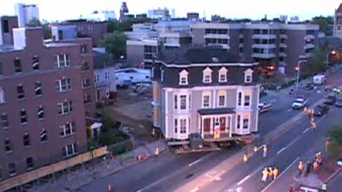 A whole house being moved down a street.