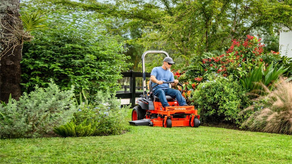 A zero-turn mower being driven through a lawn.