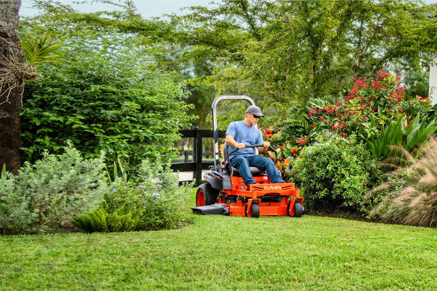A zero-turn mower being driven through a lawn.