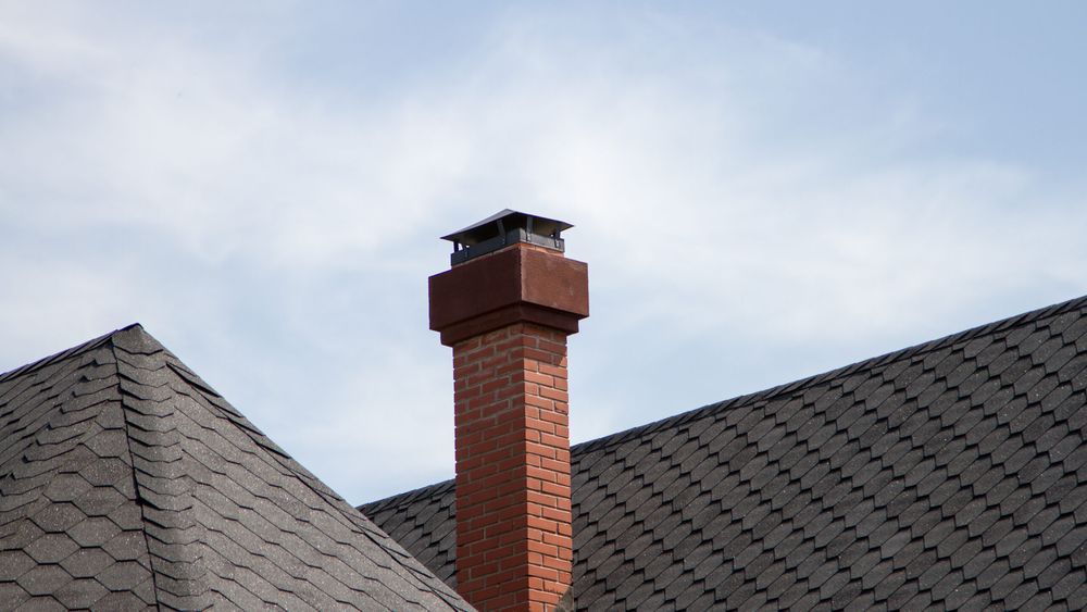 A brick chimney on a house.