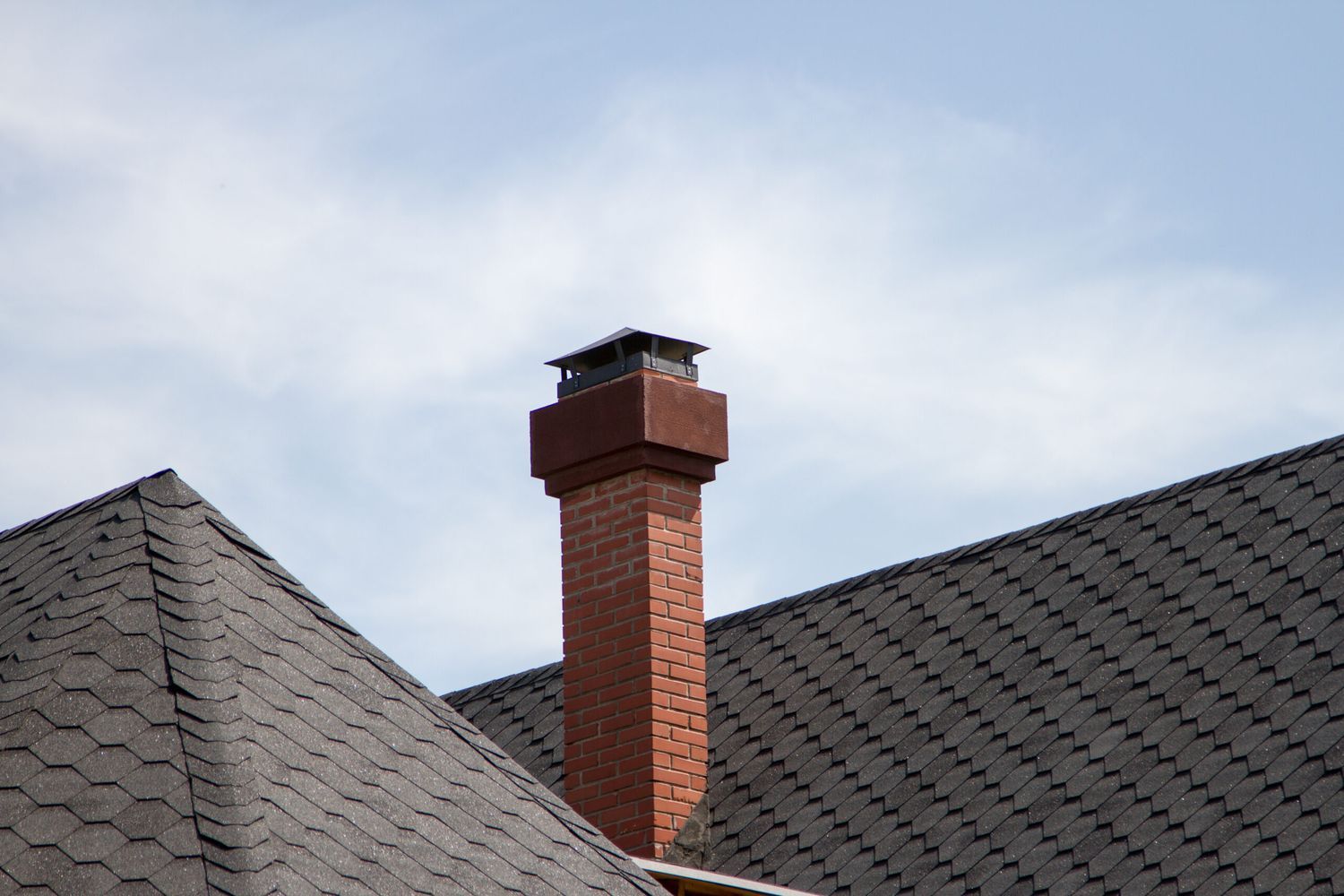 A brick chimney on a house.