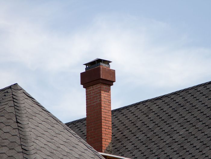A brick chimney on a house.