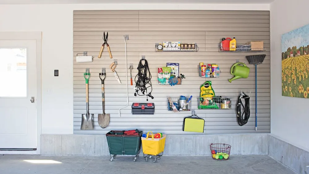 A garage with tools and supplies stored hanging organized on the wall.