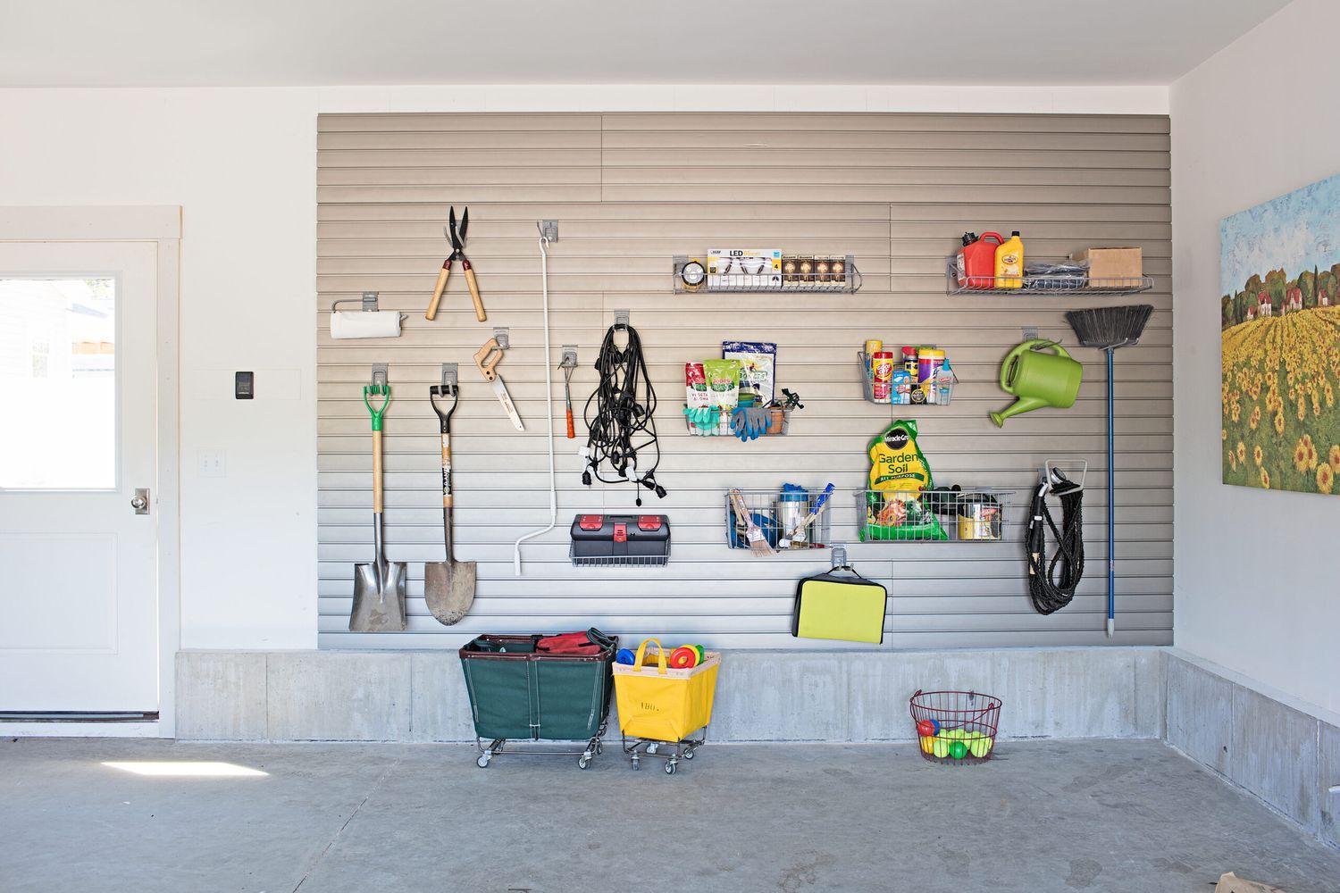 A garage with tools and supplies stored hanging organized on the wall.