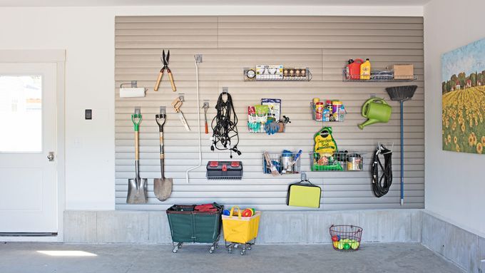 A garage with tools and supplies stored hanging organized on the wall.