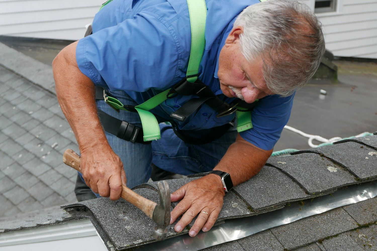 Installing a zinc strip to keep roof algae from coming back.