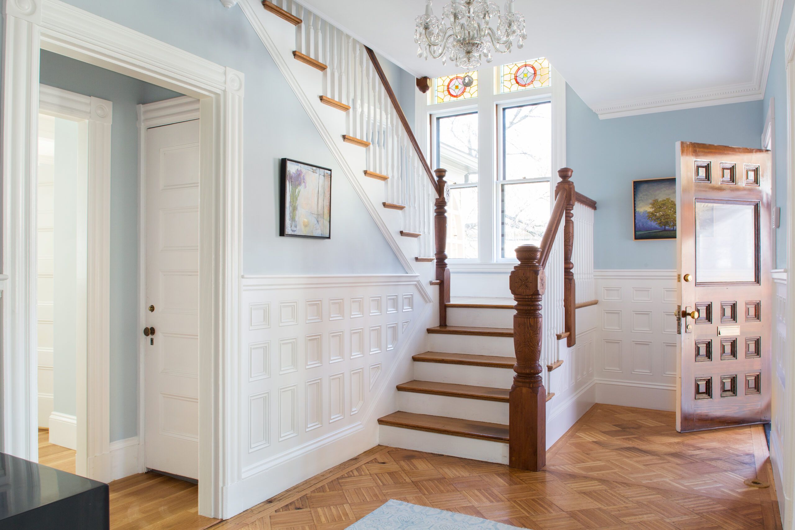 Foyer of a house with the front door open, which may be impacting humidity in the house and humidity is an important factor for allergens.