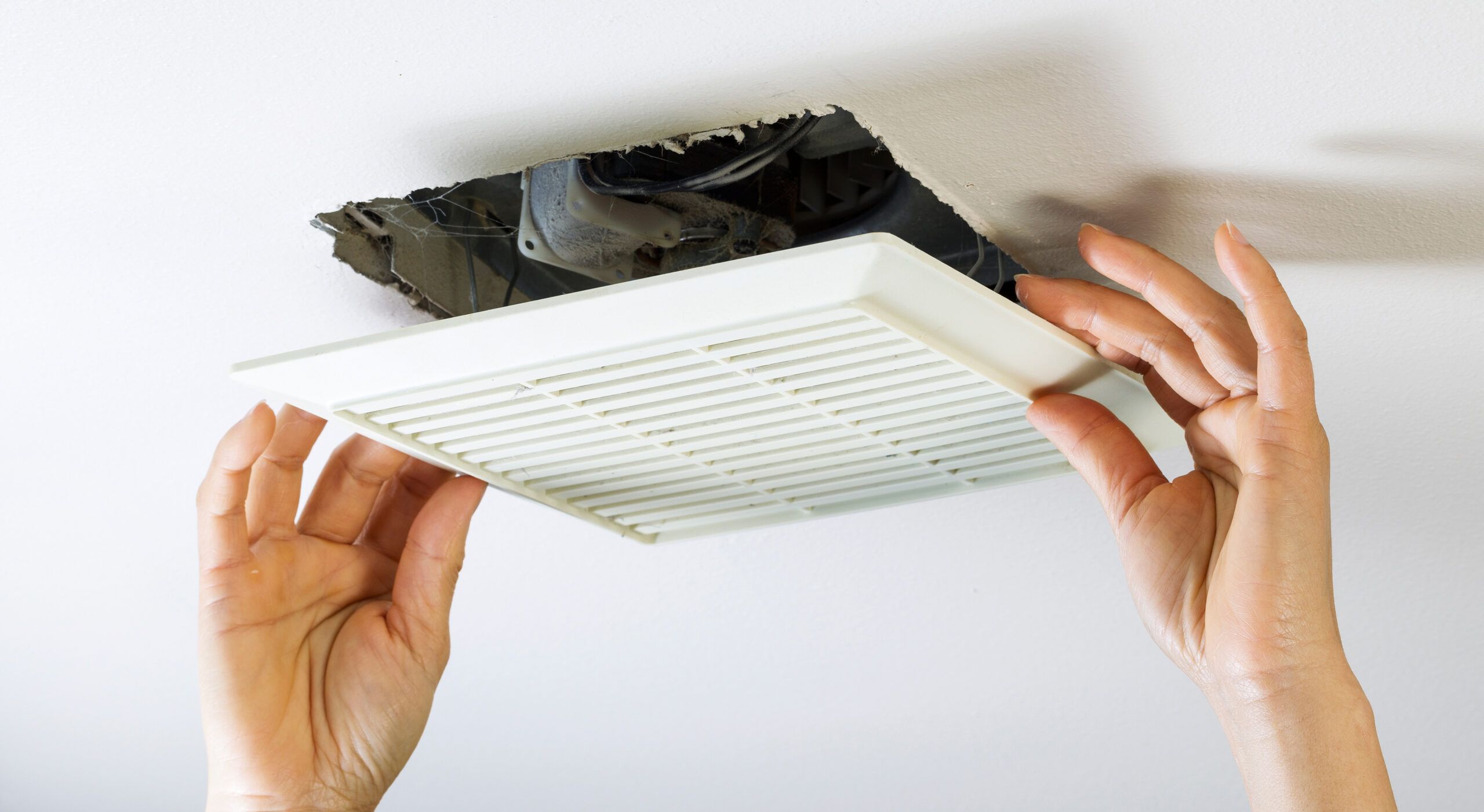 A new bathroom exhaust fan is installed into the ceiling to improve bathroom ventilation. 