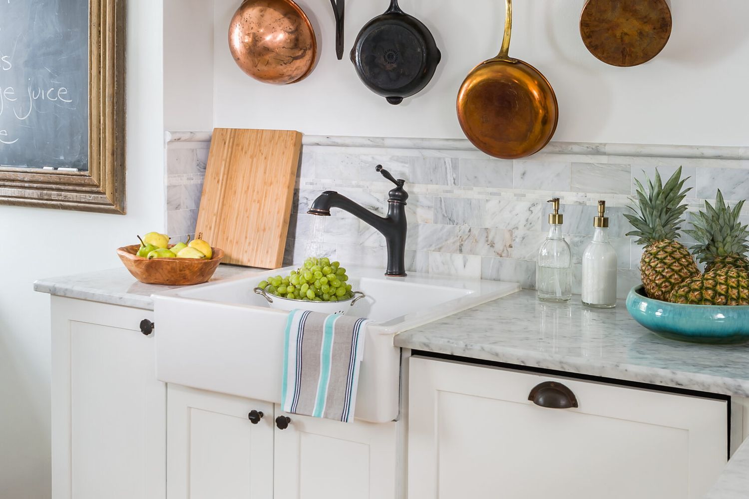 A kitchen wall with restored copper pans.