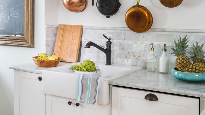 A kitchen wall with restored copper pans.