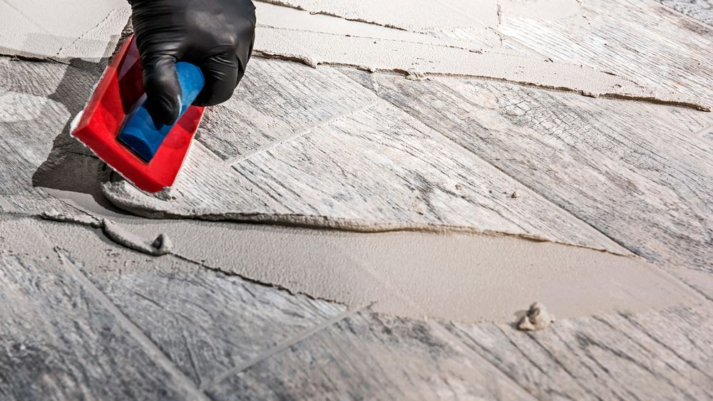 Grout being spread for tile installation.