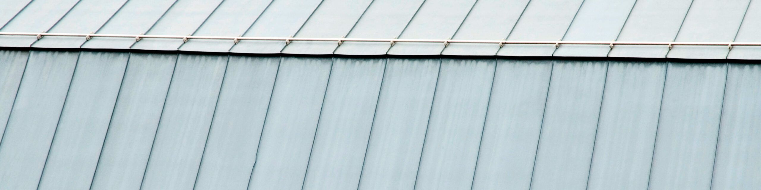 Bluish-gray zinc roofing,  which is a type of metal roofing.