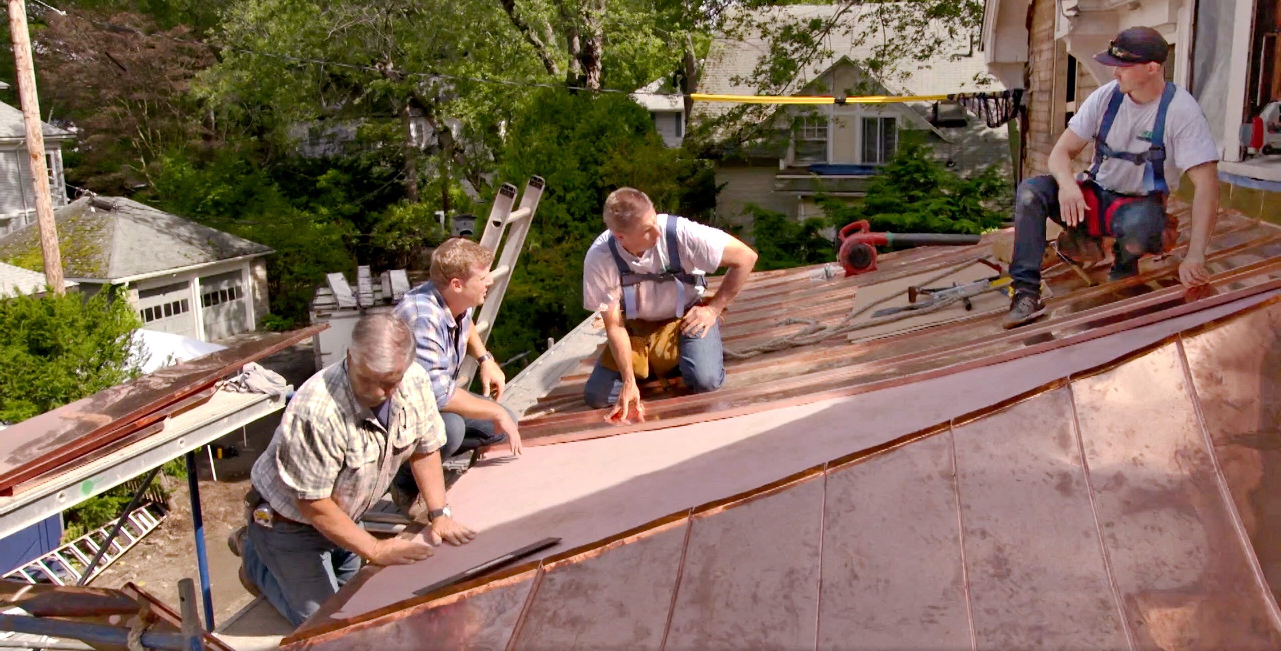 This Old House team members look at the installation of a copper standing-seam metal roof.