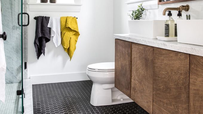 A bathroom with with black flooring.