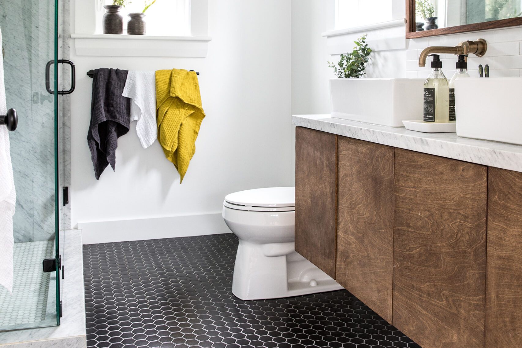 A bathroom with with black flooring.