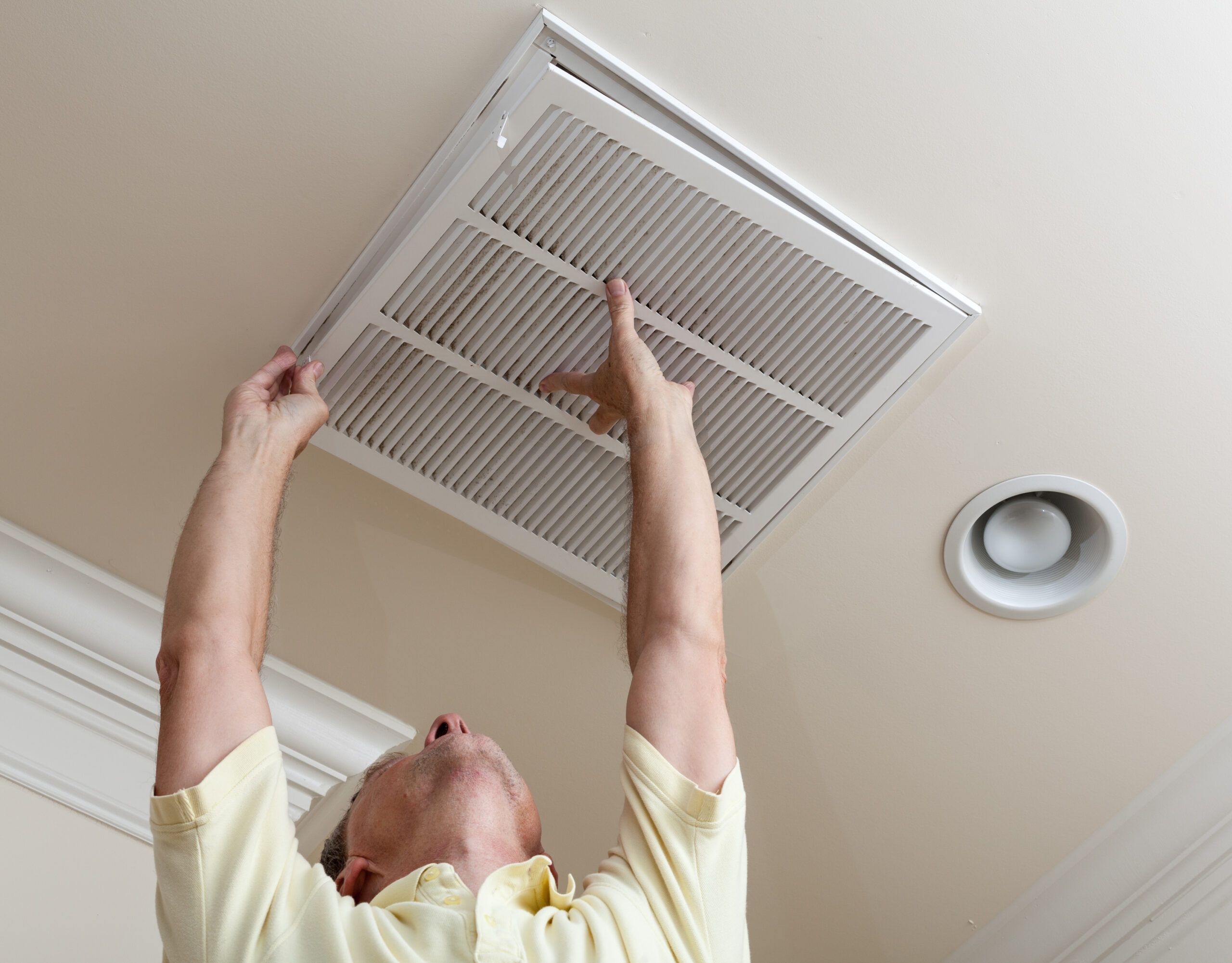 image of a homeowner changing an air filter